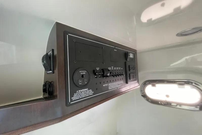 Equanimity Yacht Photos Pics 2021 Pursuit S 328 Sport control panel with switches and warning labels.