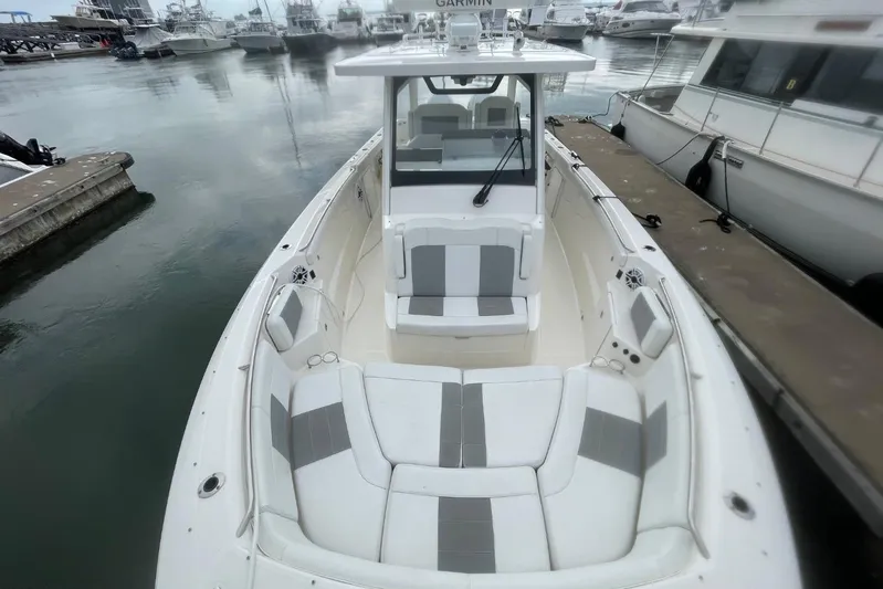 Equanimity Yacht Photos Pics 2021 Pursuit S 328 Sport boat docked, featuring spacious seating and sleek design.