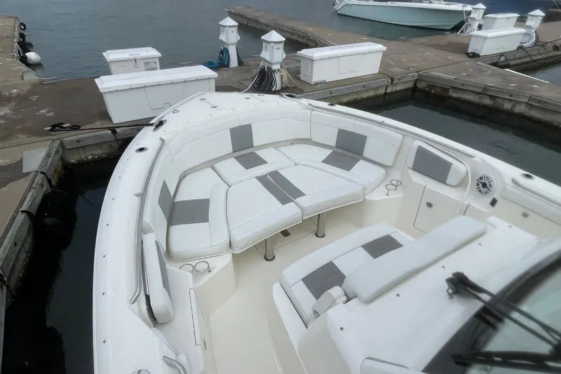 Equanimity Yacht Photos Pics 2021 Pursuit S 328 Sport boat with spacious seating at a marina dock.