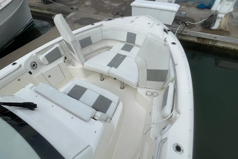 Equanimity Yacht Photos Pics 2021 Pursuit S 328 Sport boat interior with cushioned seating and storage compartments.