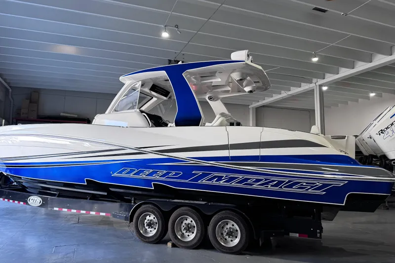  Yacht Photos Pics 2024 Deep Impact 399 Sport boat in showroom, featuring sleek blue and white design.