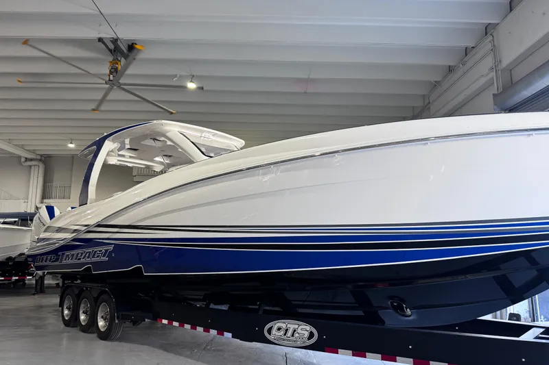  Yacht Photos Pics 2024 Deep Impact 399 Sport boat in showroom, featuring sleek design and blue accents.