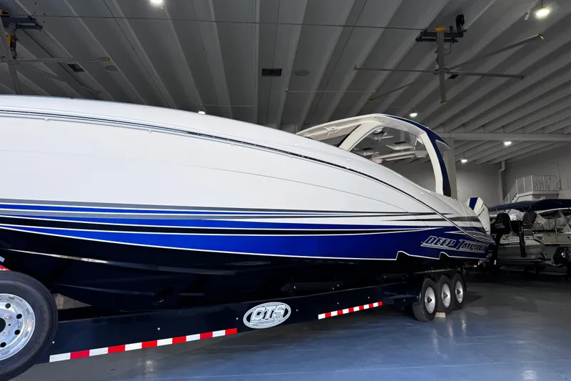  Yacht Photos Pics 2024 Deep Impact 399 Sport boat in showroom, featuring sleek design and blue accents.