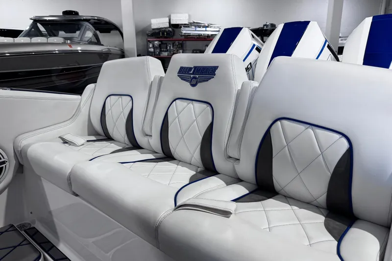  Yacht Photos Pics Luxurious white seating in 2024 Deep Impact 399 Sport boat, featuring elegant blue accents.