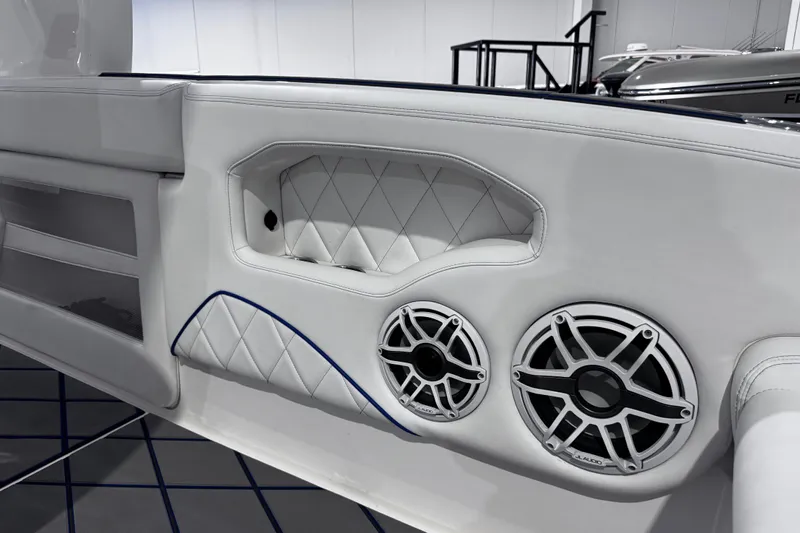  Yacht Photos Pics 2024 Deep Impact 399 Sport boat interior with white leather and dual speakers.