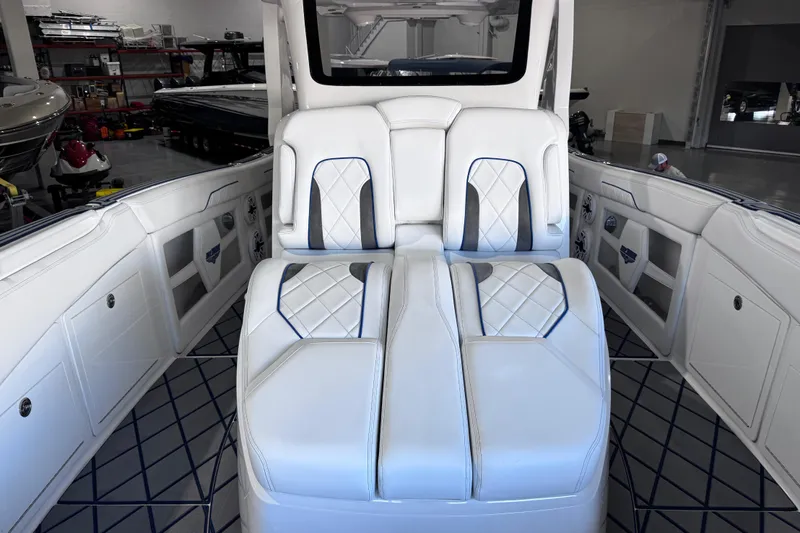  Yacht Photos Pics 2024 Deep Impact 399 Sport boat interior with luxurious white seating and blue accents.