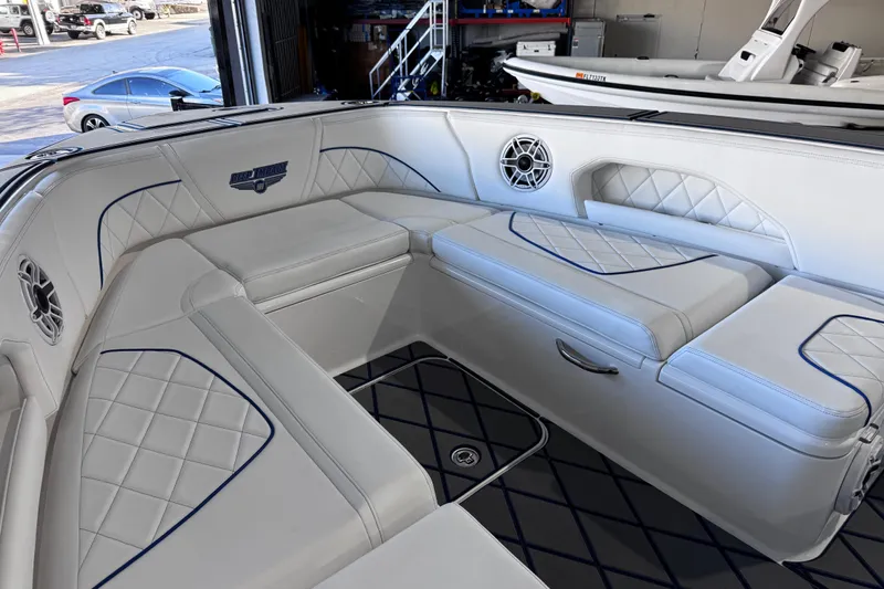  Yacht Photos Pics Luxurious interior of 2024 Deep Impact 399 Sport boat with white seating and blue accents.