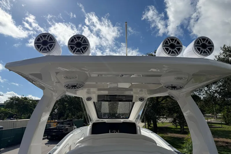  Yacht Photos Pics 2024 Deep Impact 399 Sport boat with advanced audio system under a clear sky.