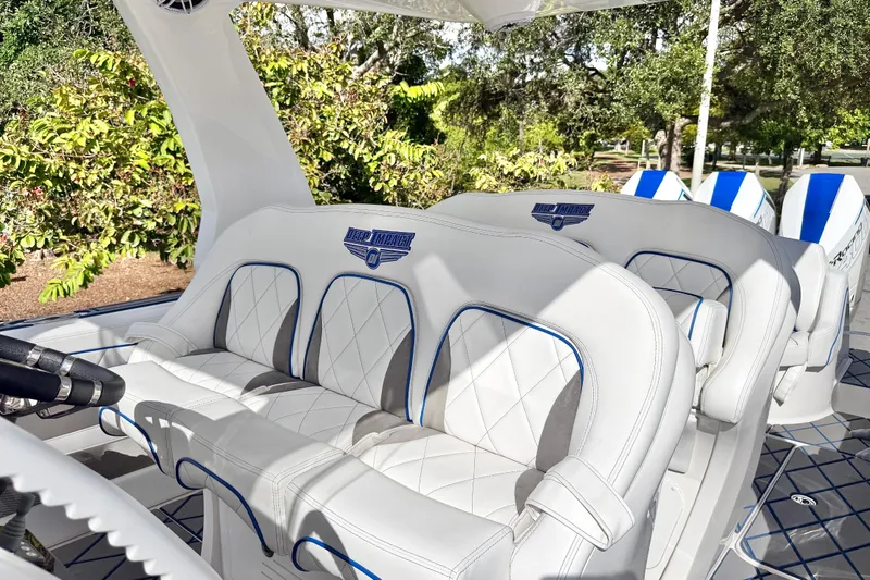  Yacht Photos Pics 2024 Deep Impact 399 Sport boat interior with luxurious white seating and blue accents.