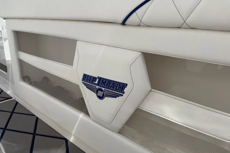  Yacht Photos Pics 2024 Deep Impact 399 Sport boat interior with logo detail and white upholstery.