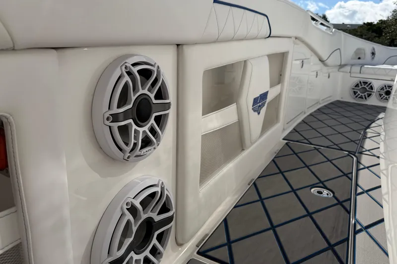  Yacht Photos Pics 2024 Deep Impact 399 Sport boat interior with speakers and stylish flooring.