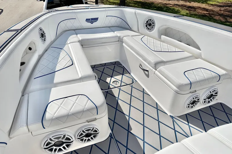  Yacht Photos Pics 2024 Deep Impact 399 Sport boat interior with white seating and blue accents.