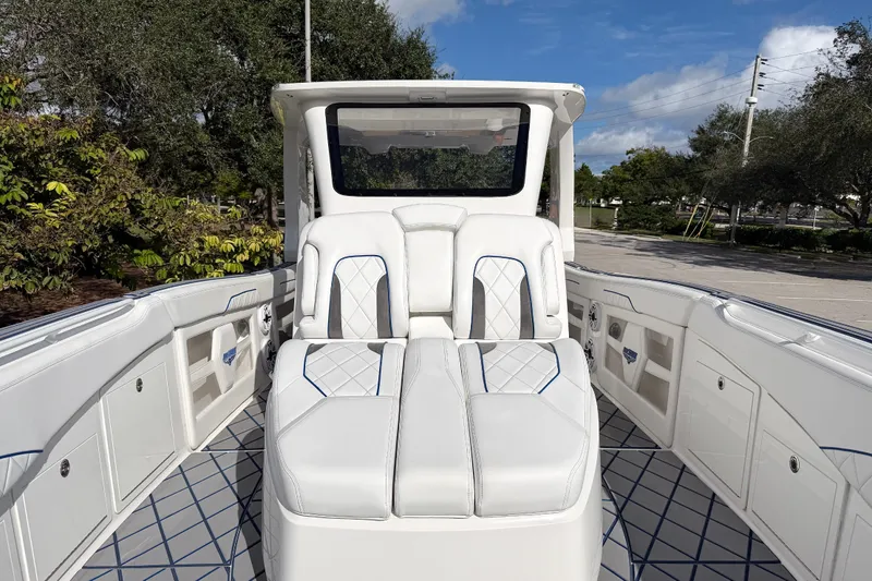  Yacht Photos Pics 2024 Deep Impact 399 Sport boat interior with luxurious white seating and modern design.