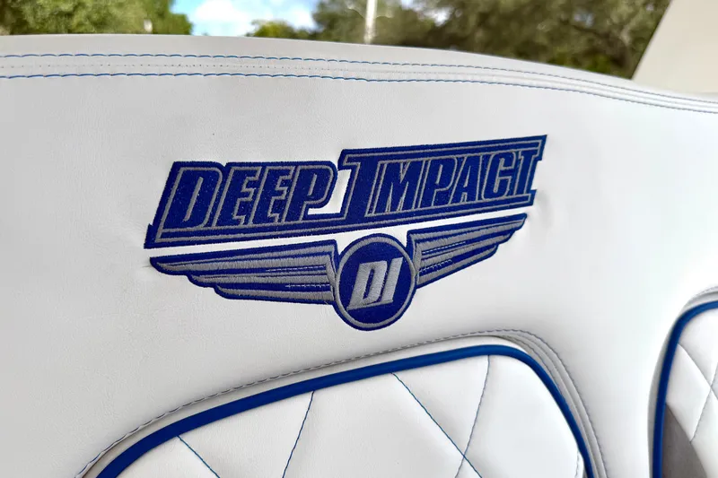  Yacht Photos Pics 2024 Deep Impact 399 Sport logo on white leather seat with blue stitching.