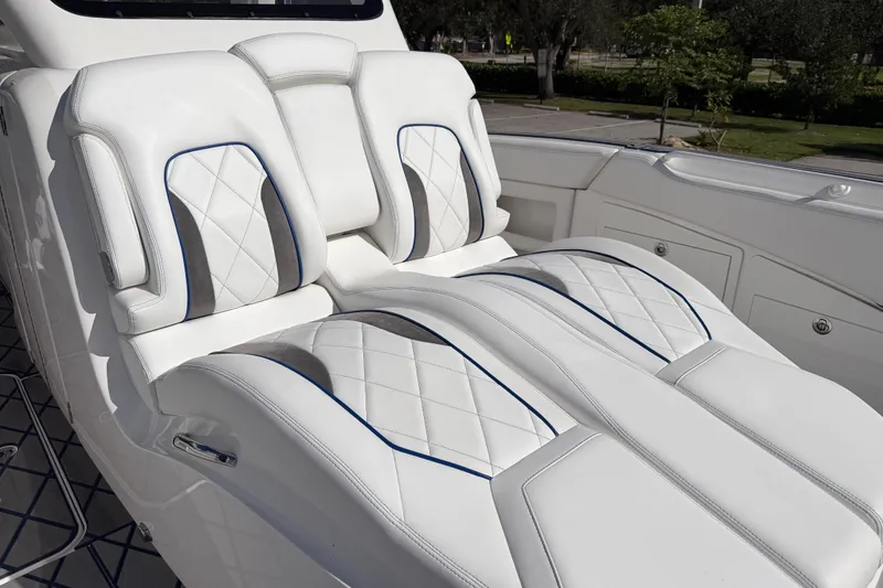  Yacht Photos Pics Luxurious white seating on 2024 Deep Impact 399 Sport boat, featuring elegant diamond stitching.