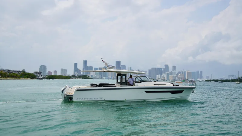 In-stock 2024 Nimbus T11 #258 Yacht Photos Pics 2024 Nimbus Tender 11 #258 cruising in a city harbor with skyline backdrop.