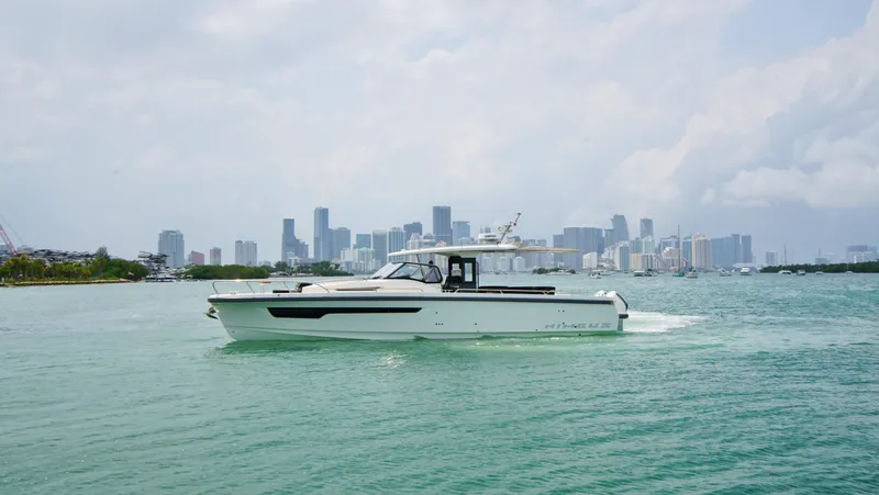 In-stock 2024 Nimbus T11 #258 Yacht Photos Pics 2024 Nimbus Tender 11 #258 cruising near a city skyline.