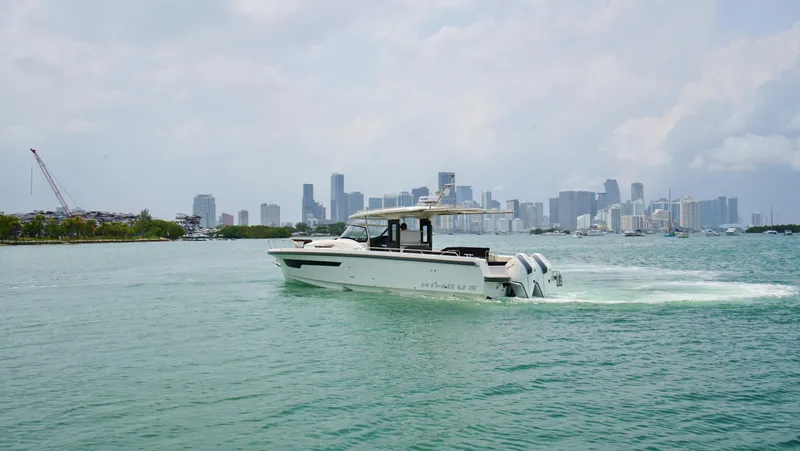 In-stock 2024 Nimbus T11 #258 Yacht Photos Pics 2024 Nimbus Tender 11 #258 cruising near a city skyline.