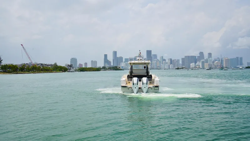 In-stock 2024 Nimbus T11 #258 Yacht Photos Pics Nimbus Tender 11 #258 (2024) cruising towards city skyline.