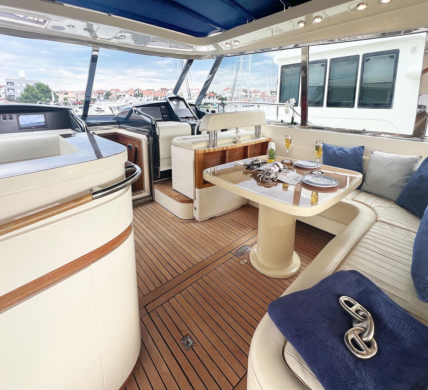 Luxurious interior of 2002 Ilver Vista 58 yacht with elegant dining setup.