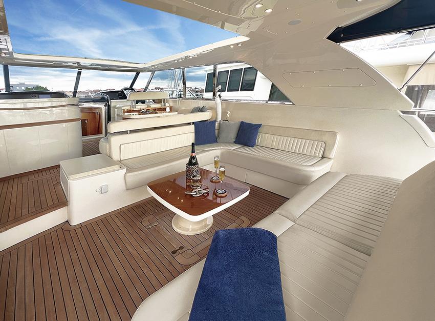 Luxurious interior of a 2002 Ilver Vista 58 yacht with elegant seating and table.