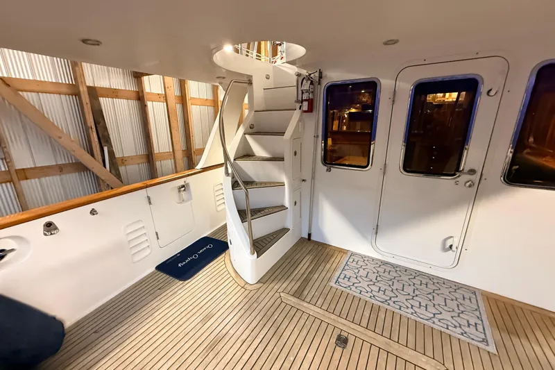 Ocean Osprey Yacht Photos Pics Interior of 2006 Selene 57 yacht with spiral staircase and wooden flooring.