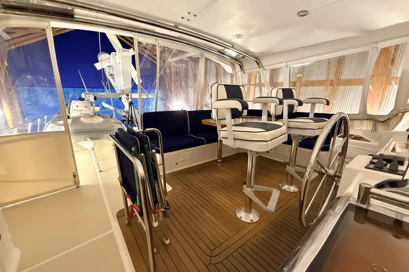 Ocean Osprey Yacht Photos Pics Luxurious 2006 Selene 57 yacht interior with helm, seating, and wooden flooring.
