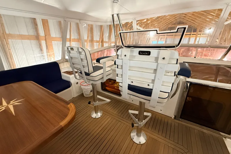 Ocean Osprey Yacht Photos Pics Interior of 2006 Selene 57 yacht with helm chairs and wooden table.