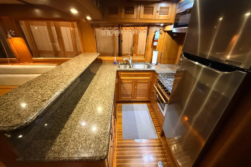 Ocean Osprey Yacht Photos Pics Luxurious 2006 Selene 57 yacht kitchen with granite countertops and stainless steel appliances.
