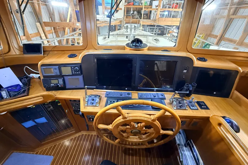 Ocean Osprey Yacht Photos Pics Pilothouse of 2006 Selene 57 yacht with wooden steering wheel and navigation equipment.