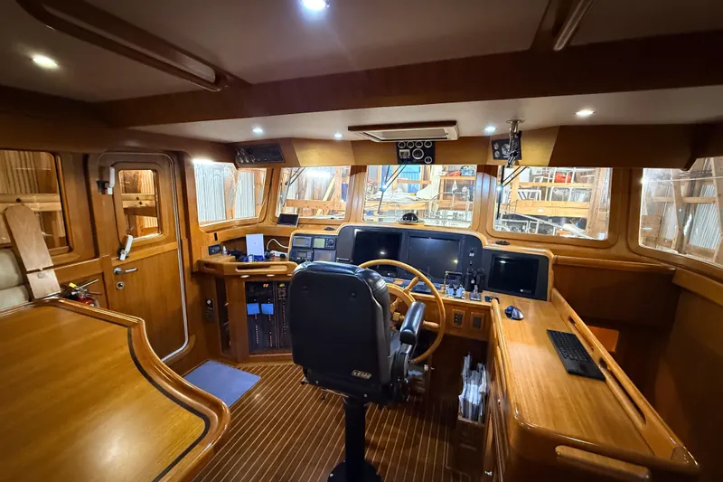 Ocean Osprey Yacht Photos Pics Luxurious 2006 Selene 57 yacht interior with wooden helm and modern navigation equipment.