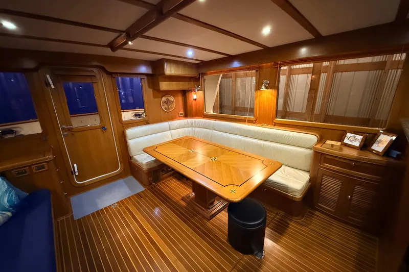 Ocean Osprey Yacht Photos Pics Luxurious interior of 2006 Selene 57 yacht with elegant wood finish and cozy seating area.