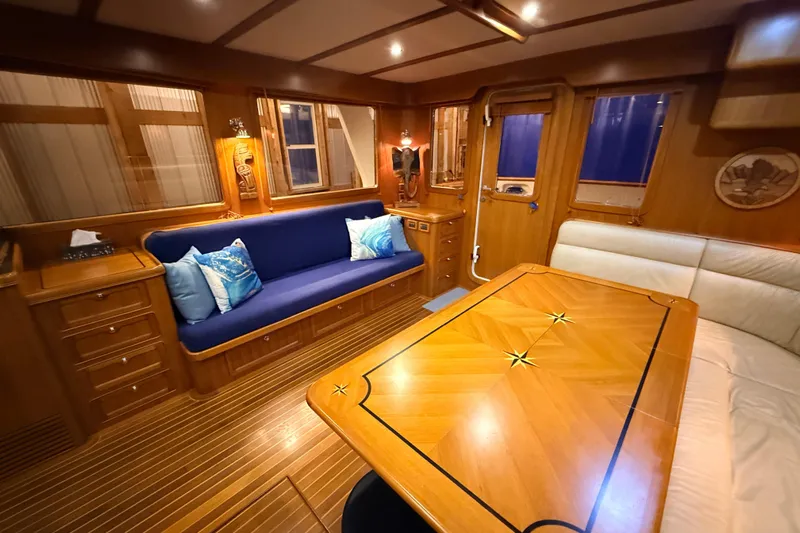 Ocean Osprey Yacht Photos Pics Luxurious interior of a 2006 Selene 57 yacht with elegant wood finishes and cozy seating.