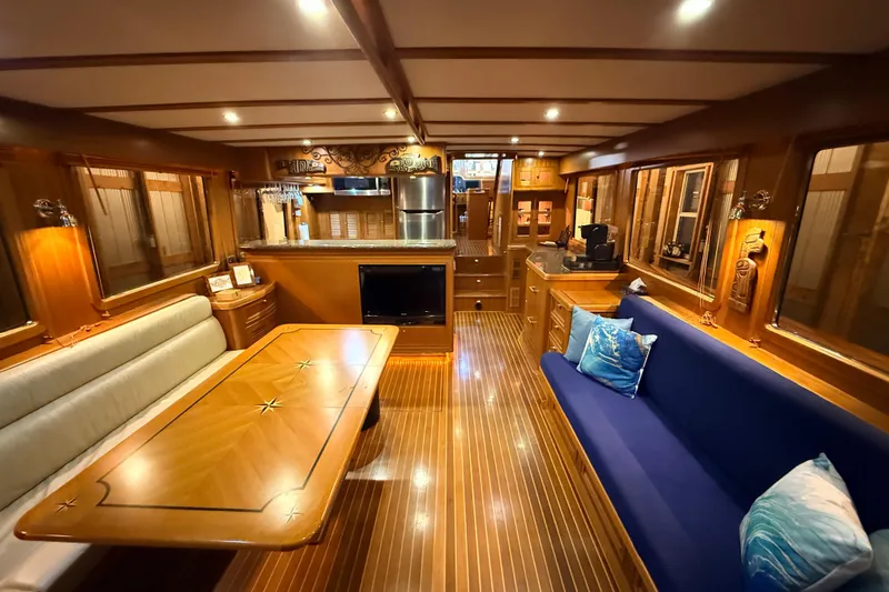 Ocean Osprey Yacht Photos Pics Luxurious interior of a 2006 Selene 57 yacht with elegant wood finishes and cozy seating.