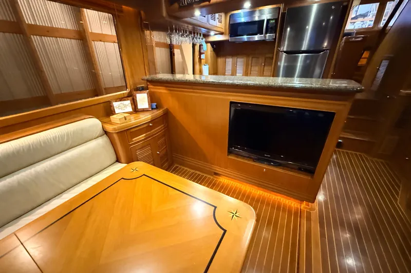 Ocean Osprey Yacht Photos Pics Luxurious 2006 Selene 57 yacht interior with wood finish, dining area, and modern kitchen appliances.