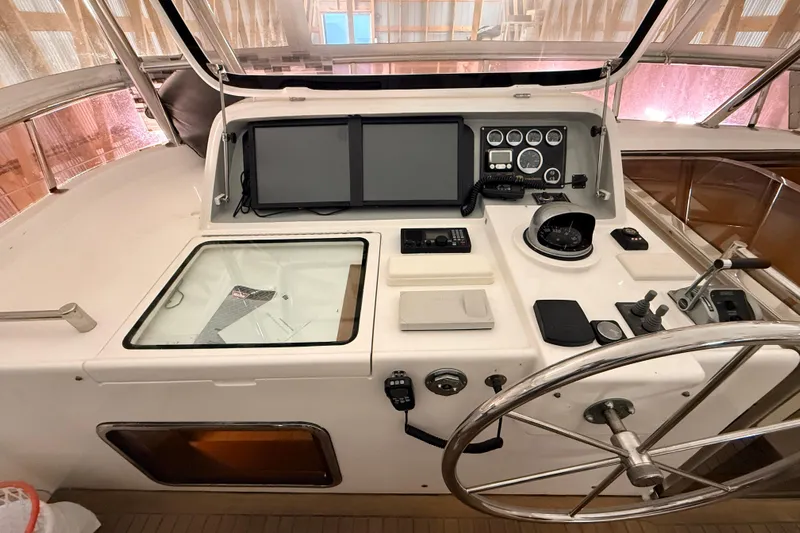 Ocean Osprey Yacht Photos Pics Helm of 2006 Selene 57 yacht with navigation instruments and steering wheel.