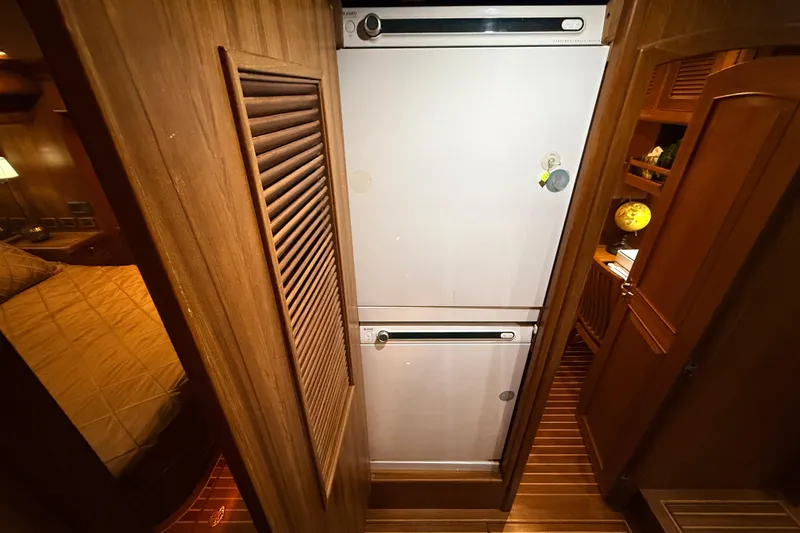 Ocean Osprey Yacht Photos Pics Wood-paneled interior of 2006 Selene 57 yacht with built-in refrigerator.