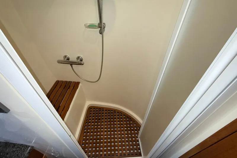 Ocean Osprey Yacht Photos Pics Compact shower area with wooden bench and floor in 2006 Selene 57 yacht.