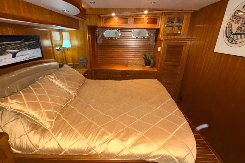 Ocean Osprey Yacht Photos Pics Luxurious cabin interior of 2006 Selene 57 yacht with elegant bedding and wooden finishes.