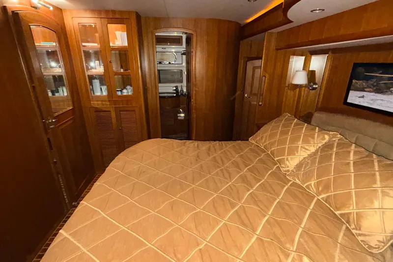 Ocean Osprey Yacht Photos Pics Luxurious cabin interior of 2006 Selene 57 yacht with wooden furnishings and cozy bedding.