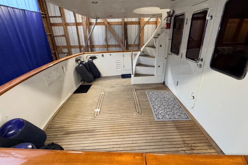 Ocean Osprey Yacht Photos Pics Spacious deck of 2006 Selene 57 yacht with wooden flooring and staircase.