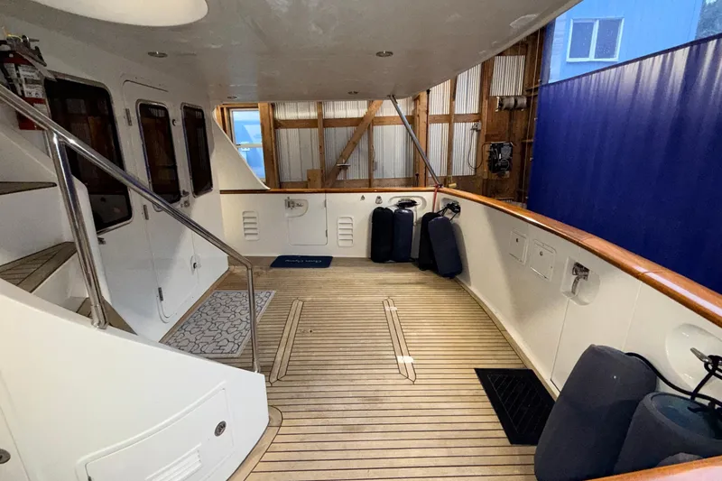 Ocean Osprey Yacht Photos Pics Spacious deck of 2006 Selene 57 yacht with wooden flooring and safety railings.