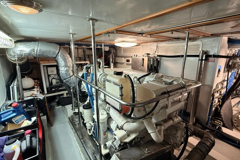 Ocean Osprey Yacht Photos Pics Engine room of a 2006 Selene 57 yacht, featuring machinery and storage items.