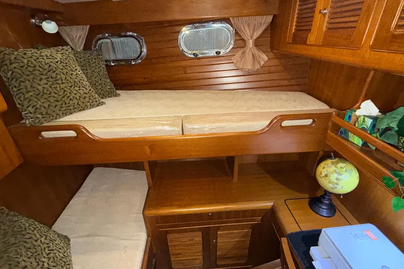 Ocean Osprey Yacht Photos Pics Cozy cabin interior of 2006 Selene 57 yacht with wooden bunk beds and nautical decor.