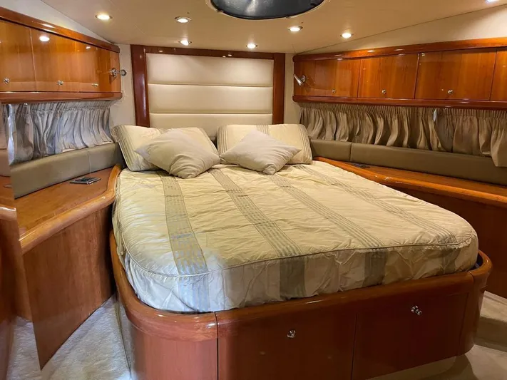  Yacht Photos Pics Luxurious cabin interior of 2005 Sunseeker Mk1 yacht with elegant wood finish and cozy bedding.