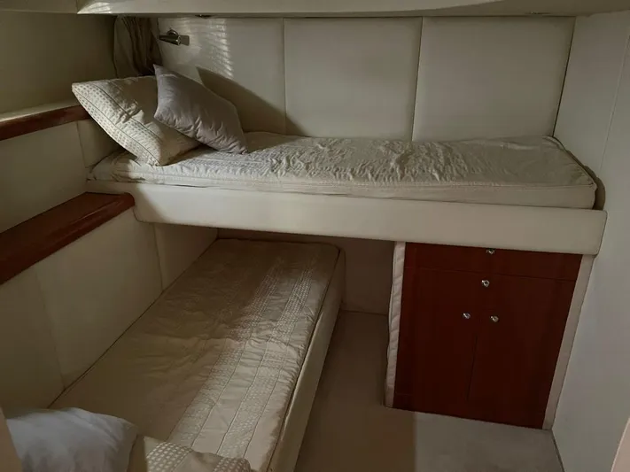  Yacht Photos Pics Interior of 2005 Sunseeker Mk1 yacht with twin bunk beds and wooden cabinetry.
