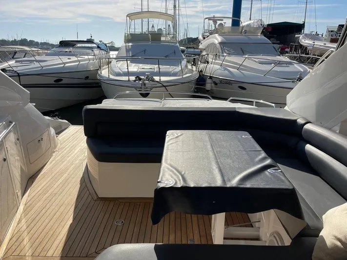  Yacht Photos Pics Sunseeker Mk1 2005 yacht with spacious deck, docked among other boats in a marina.