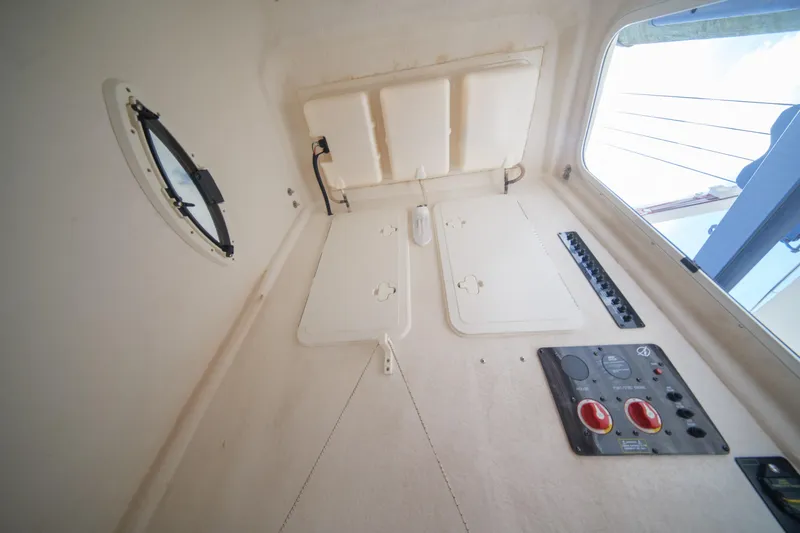  Yacht Photos Pics Interior view of 2015 Sailfish 320 CC boat cabin with control panels and porthole.