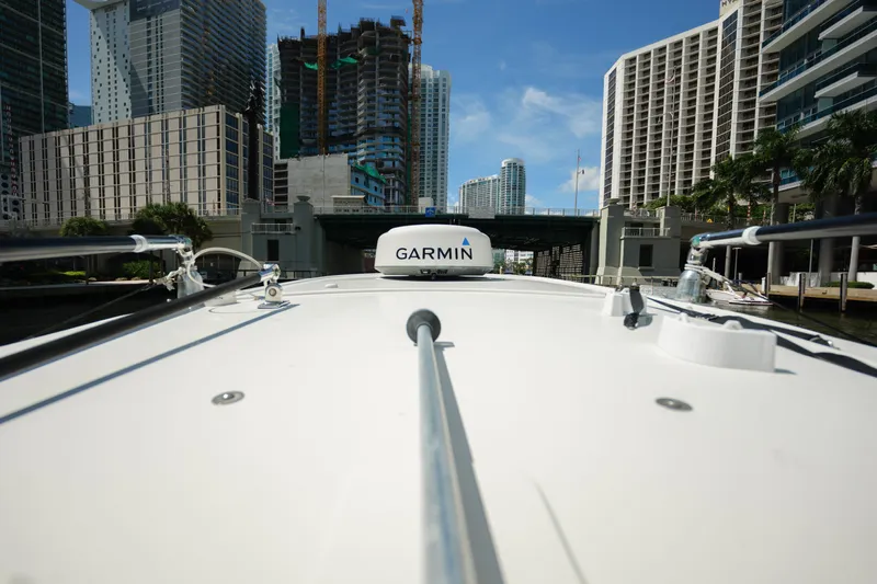  Yacht Photos Pics 2015 Sailfish 320 CC boat navigating urban waterway with Garmin equipment.