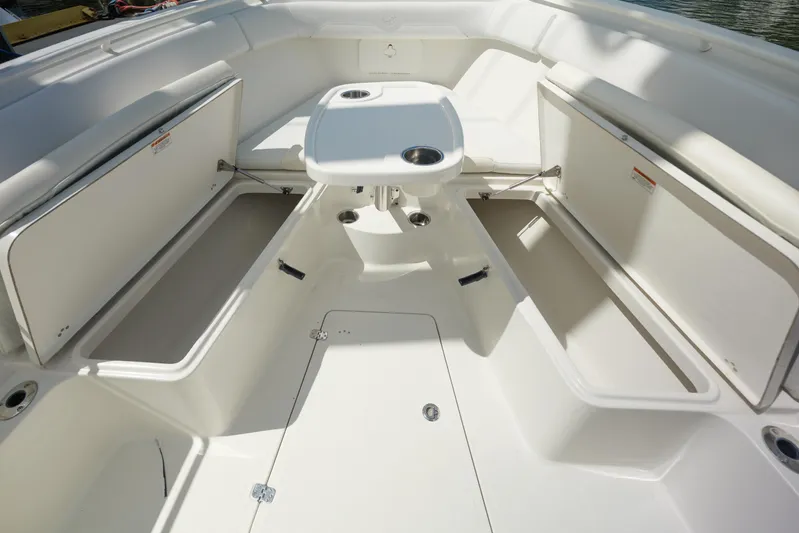  Yacht Photos Pics 2015 Sailfish 320 CC boat interior with open storage compartments and table.